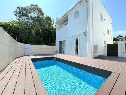a house with a swimming pool next to a building at OKINAWA POOLWILLA ONNA 4A - Vacation STAY 48422v in Baba