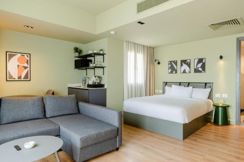 a hotel room with a bed and a couch at grey l studio apartments Downtown Cairo Ouzonian House in Cairo