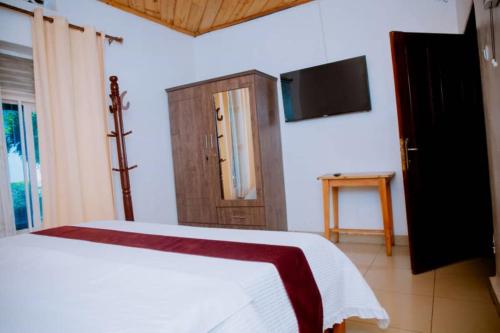 Ένα ή περισσότερα κρεβάτια σε δωμάτιο στο Gmasters Homes Kabeza