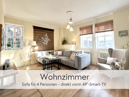 uma sala de estar com um sofá e uma mesa em GRÄFIN ANNA - Design-Apartment mit 2 Schlafzimmer - in der historischen Hinterburg Schlitz - mit Aufzug, Parkplatz & Garten - Hunde willkommen em Schlitz