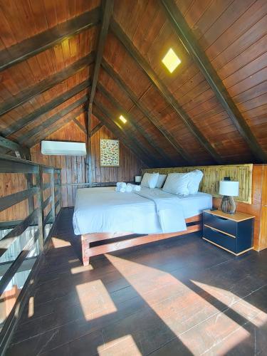 a bedroom with a large bed in a wooden ceiling at Pousada do Parque in Chapada dos Guimarães