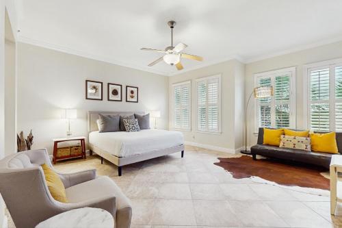 a bedroom with a bed and a couch at Sunset Retreat in Panama City Beach