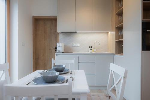 a kitchen with a table with two bowls on it at Môj Hillside in Dolný Kubín