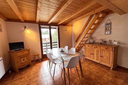a dining room with a glass table and chairs at Alpine stay at the foot of the slopes in Crest-Voland
