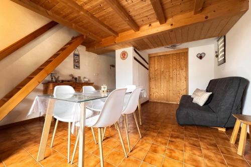 a dining room with a glass table and white chairs at Alpine stay at the foot of the slopes in Crest-Voland