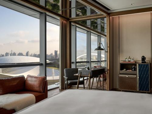 a bedroom with a bed and a view of the city at Thompson Shanghai Expo, by Hyatt in Shanghai