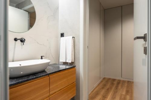 a bathroom with a sink and a mirror at Extra Large 2BR Apartment Next to Metro Station in Bicas