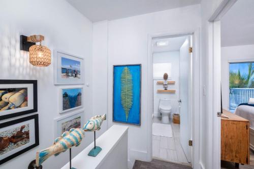 a white room with a hallway with a bathroom at Saltwater Lagoon Front View, Marina, Kayaks in Key Largo