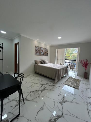 a bedroom with a bed and a marble floor at Apartamento grande em Santa Teresa-ES in Santa Teresa