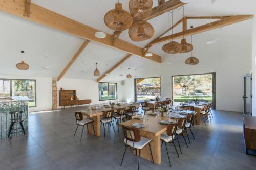 a dining room with wooden tables and chairs at DOMAINE De PLAISANCE in Cachen