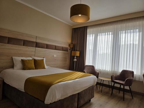 a hotel room with a bed and a table and chairs at Hotel de France in Brussels