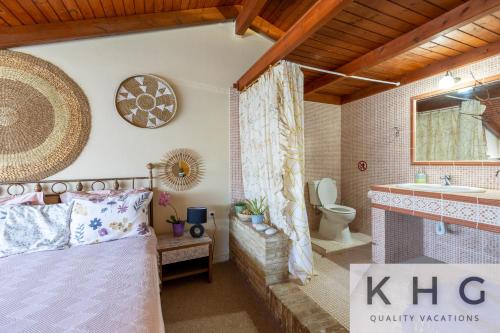 a bathroom with a bed and a sink and a toilet at Anti-Pera Cottage with private pool in Dilinata village! in Argostoli