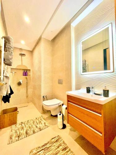 a bathroom with a sink and a toilet and a window at Maison Miralin Beach in Hammam Sousse