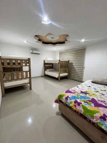 a bedroom with two beds and a ceiling at Cabaña Ivan in Santa Marta