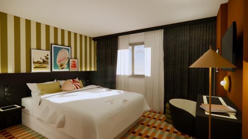 Postel nebo postele na pokoji v ubytování Le Colisée Nantes St Herblain