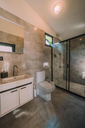 a bathroom with a toilet and a sink and a shower at Monk Living Space in Kocaeli