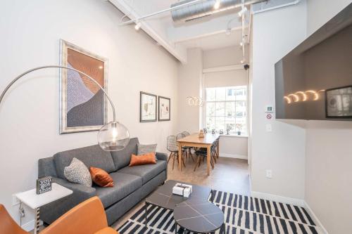 a living room with a couch and a table at The 333 Suites 202 - Stay for 6 in Cincinnati