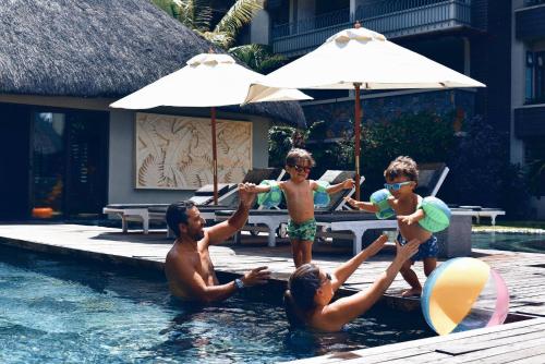 a group of people in a swimming pool at Residence Alizees Spa in Mauritius