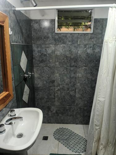 a bathroom with a sink and a shower at Depto 4 in Sierra de la Ventana