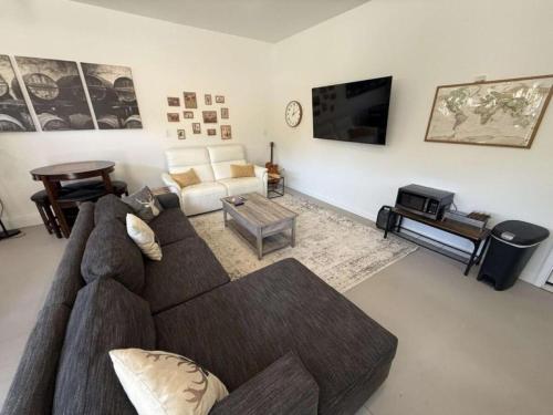 a living room with a couch and a tv at Stunning Cabin Rental for Glamping Escapes Between Bryce Canyon and Zion National Park in Long Valley Junction