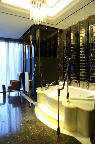 a bathroom with a tub and a large glass wall at Kempinski Hotel Fuzhou in Fuzhou