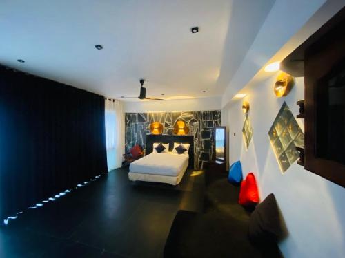 a bedroom with a bed in a room with lights at Cloudora Inn Kandy in Kandy