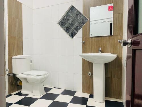 a bathroom with a toilet and a sink at Cloudora Inn Kandy in Kandy