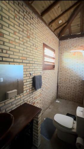 a bathroom with a toilet and a sink at Bangalô raizes in São Gonçalo do Amarante