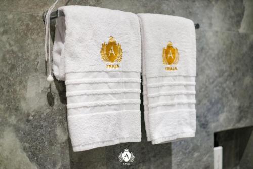 a group of towels hanging on a rack in a bathroom at Hotel Kraja in Golem