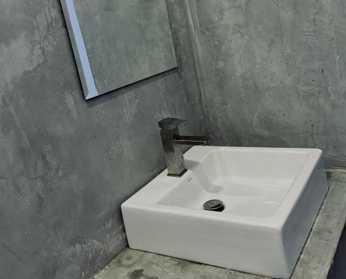 a white sink in a bathroom with a mirror at The Lotus House - Ahangama in Ahangama