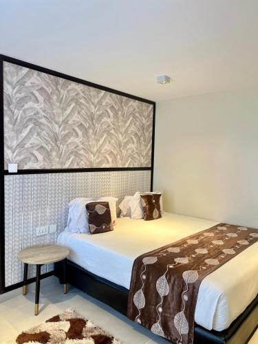 a bedroom with a large bed and a table and apill sqor at Hadassah Hotel in Nairobi