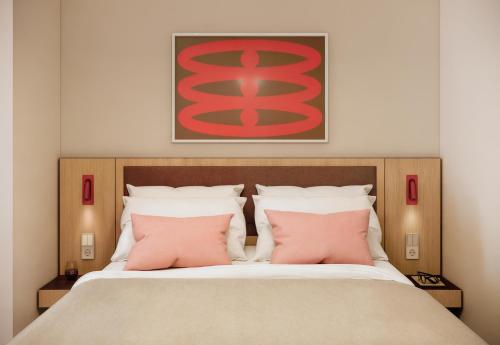 En eller flere senge i et værelse på Numa Madrid Fuencarral