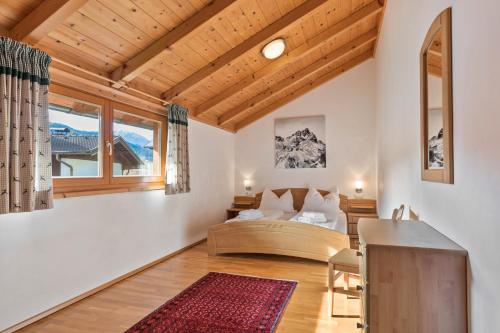 a living room with a bed and a table at Skiblickhaus in Russbach am Pass Gschütt