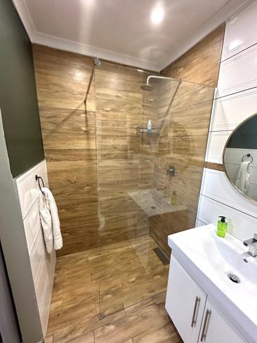 a bathroom with a shower and a sink at 29 Windsor Flatlet 2 in Silver Sands