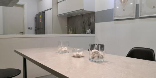 a table with two glass vases on it in a kitchen at M City in Kuala Lumpur