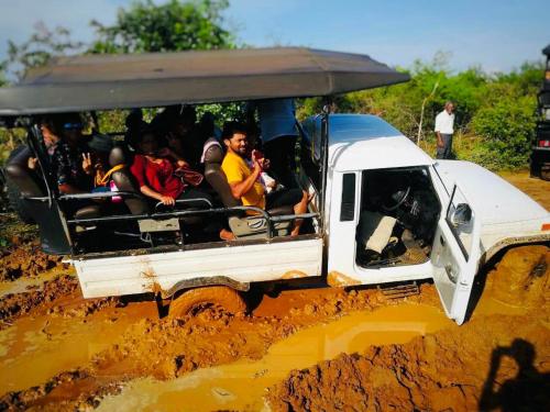 a group of people in the back of a white vehicle in a muddy at Elephant's Nest Udawalawe in Udawalawe