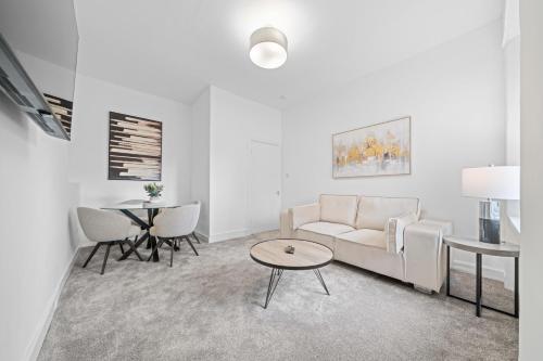 a living room with a couch and a table at Spacious 2 Bed Apartment - Perfect for Long or Short Stays - Sleeps 4 - Free On Street Parking in Fife