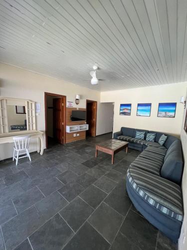 a living room with a couch and a table at Casa na praia do Guaiuba in Guarujá