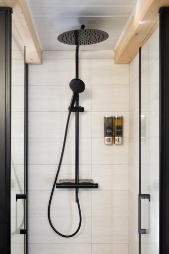 a shower with a shower head in a bathroom at Le Jardin D' Épicure in Oderen