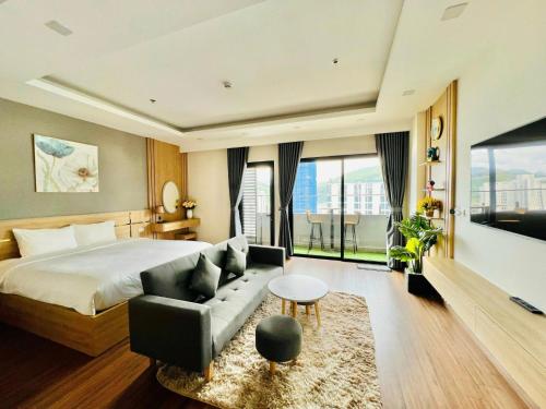 a hotel room with a bed and a couch at FLC Sea Tower - Sea view Quy Nhơn in Quy Nhon