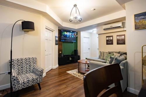 a living room with a couch and a chair at 3 Bdr Apartment close to Port of Spain in Diego Martin