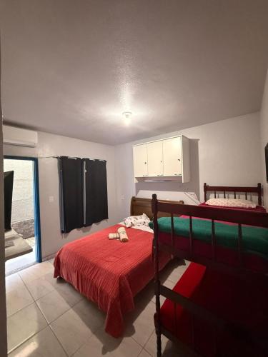 a bedroom with a bed with a red blanket at Pousada São José in Itatiaia