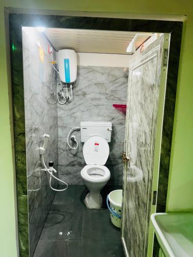 a small bathroom with a toilet and a shower at Sunrise Resort in Araku
