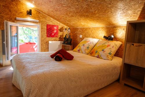 a bedroom with a bed with a teddy bear on it at Le Jardin D' Épicure in Oderen