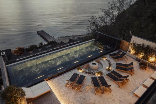 een uitzicht op een zwembad met stoelen en het water bij Dayone Kilyos Hotel in Kilyos