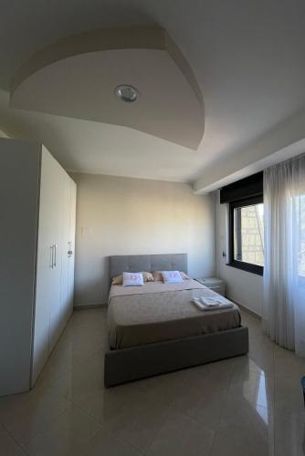 a bedroom with a large bed and a window at B&B Villa Diamante in Scafati