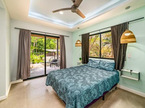 a bedroom with a bed and a large window at The Wave House in Santa Cruz