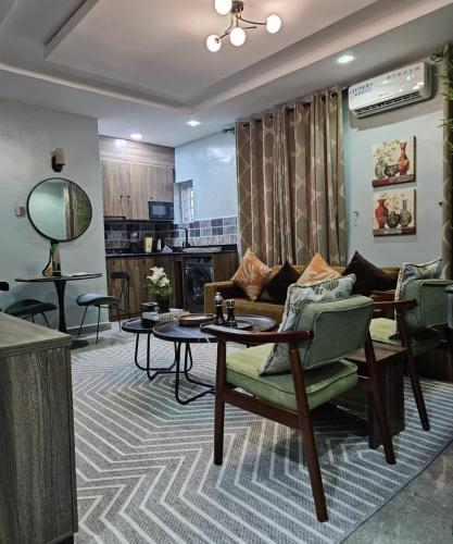 a living room with a couch and a table at Smartcribs 1 Bedroom Solar Powered Apartment, GRA in Port Harcourt