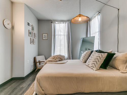 a bedroom with a large bed and a window at Boho, Walk East Village, Downtown, Free Parking in Des Moines