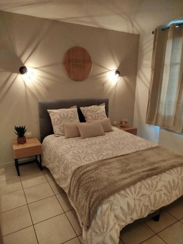 a bedroom with a large bed and a sign on the wall at Chez Louis in Levernois